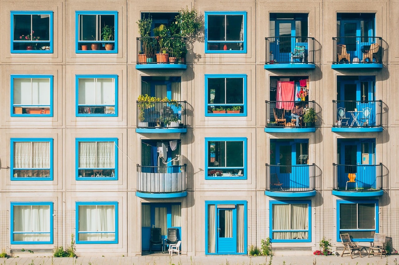 Apartment building with balconies and windows, illustrating how surrounding buildings and orientation affect balcony sunlight