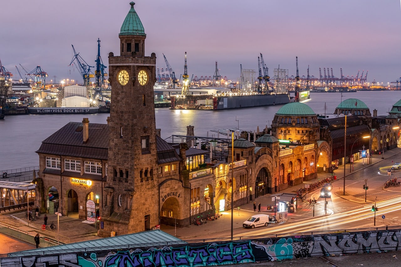 Harbour clock tower at dusk with street lights on and the sky still faintly lit